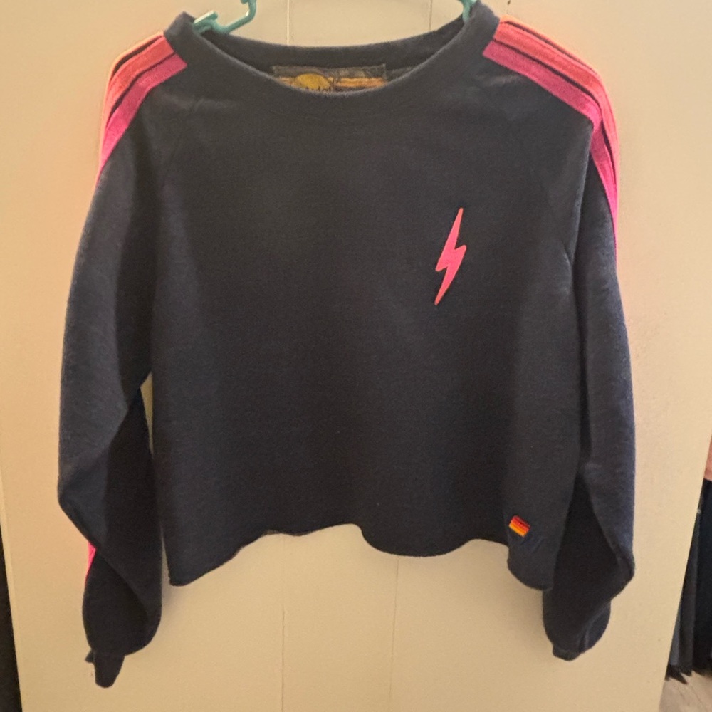 Excellent condition navy raw edge with pink lightning bolt. 
Size M